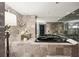 Luxurious bathroom with a black soaking tub, marble accents, and ambient lighting at 3475 Oak Valley Ne Rd # 1720, Atlanta, GA 30326