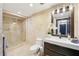 Elegant bathroom featuring a sleek vanity with countertop, a glass-enclosed shower, and stylish travertine tile at 3475 Oak Valley Ne Rd # 1720, Atlanta, GA 30326