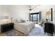 Serene bedroom with neutral tones, a ceiling fan, and a large window offering a city view at 3475 Oak Valley Ne Rd # 1720, Atlanta, GA 30326