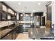 Modern kitchen with stainless appliances, custom cabinets, and breakfast bar at 3475 Oak Valley Ne Rd # 1720, Atlanta, GA 30326