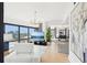 Open-concept living room with hardwood floors, stylish furniture, and city views through large windows at 3475 Oak Valley Ne Rd # 1720, Atlanta, GA 30326