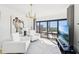 Bright living room featuring white sofas, a modern chandelier, and expansive windows with a city view at 3475 Oak Valley Ne Rd # 1720, Atlanta, GA 30326