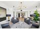 Comfortable living space featuring armchairs, modern chandelier, and view of dining area with bar at 3475 Oak Valley Ne Rd # 1720, Atlanta, GA 30326