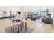 Bright open-plan living area featuring floor-to-ceiling windows, light wood floors, and elegant contemporary furnishings at 3475 Oak Valley Ne Rd # 1720, Atlanta, GA 30326