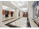 Elegant lobby with marble floors, wood trim, columns, recessed lighting, and a reception desk at 3475 Oak Valley Ne Rd # 1720, Atlanta, GA 30326