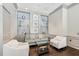 Stylish lounge with comfortable seating, glass shelving, wainscoting, and hardwood floors at 3475 Oak Valley Ne Rd # 1720, Atlanta, GA 30326