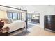 Bright main bedroom with a four-poster bed, city views from the window, large mirror, and hardwood floors at 3475 Oak Valley Ne Rd # 1720, Atlanta, GA 30326