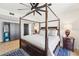 A sophisticated main bedroom features a four-poster bed, a modern fan, and hardwood floors at 3475 Oak Valley Ne Rd # 1720, Atlanta, GA 30326