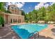 Inviting community pool with lounge chairs, umbrellas, and landscaped surroundings at 3475 Oak Valley Ne Rd # 1720, Atlanta, GA 30326