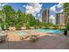 Sparkling community pool surrounded by lounge chairs and lush greenery at 3475 Oak Valley Ne Rd # 1720, Atlanta, GA 30326
