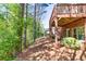 Backyard view of wooden deck and walkout basement, showing landscaping and tree line at 3810 Baverton Dr, Suwanee, GA 30024