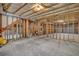 Unfinished basement with concrete flooring and exposed insulation and duct work on the ceiling at 3810 Baverton Dr, Suwanee, GA 30024