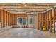 Unfinished basement with concrete flooring and an exterior door and window allowing for natural light at 3810 Baverton Dr, Suwanee, GA 30024