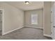 Cozy bedroom with neutral walls, carpeted floor, and a window for natural light at 3810 Baverton Dr, Suwanee, GA 30024