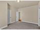 Neutral bedroom featuring a carpeted floor and two entryways with crisp white doors at 3810 Baverton Dr, Suwanee, GA 30024