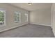 Bedroom with neutral walls, gray carpeting and large windows allowing for lots of natural light at 3810 Baverton Dr, Suwanee, GA 30024