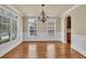 Elegant dining room with hardwood floors, wainscoting, large windows and chandelier at 3810 Baverton Dr, Suwanee, GA 30024