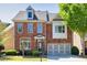 Charming brick two-story home with well-maintained landscaping and attached two-car garage at 3810 Baverton Dr, Suwanee, GA 30024