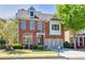 Charming brick two-story home with well-maintained landscaping and attached two-car garage at 3810 Baverton Dr, Suwanee, GA 30024