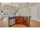 Bright kitchen boasts granite countertops, stainless steel appliances, hardwood floors and view of staircase at 3810 Baverton Dr, Suwanee, GA 30024