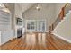 Spacious living room with fireplace, wooden floors, staircase, large windows, and plenty of natural light at 3810 Baverton Dr, Suwanee, GA 30024