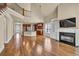 Bright, open living area with fireplace, hardwood floors, and views into the kitchen and staircase at 3810 Baverton Dr, Suwanee, GA 30024