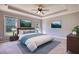Bright bedroom features a tray ceiling, ceiling fan, and natural light from two windows at 72 Grayson New Hope Rd, Grayson, GA 30017