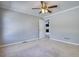 Bedroom with ceiling fan, neutral paint, carpet flooring, and door leading to hallway at 72 Grayson New Hope Rd, Grayson, GA 30017