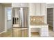 Kitchen with stainless steel refrigerator, white cabinets, and a built-in desk at 72 Grayson New Hope Rd, Grayson, GA 30017
