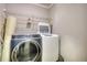 Functional laundry room with modern washer and dryer, complemented by wire shelving for storage at 72 Grayson New Hope Rd, Grayson, GA 30017