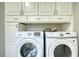 Laundry room features a full-size washer and dryer, along with ample storage cabinets at 72 Grayson New Hope Rd, Grayson, GA 30017