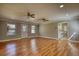 Large living room features hardwood flooring, natural light, access to a laundry room, and neutral paint at 72 Grayson New Hope Rd, Grayson, GA 30017