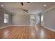 Spacious living room with hardwood floors, neutral paint, a ceiling fan, and natural light from large windows at 72 Grayson New Hope Rd, Grayson, GA 30017