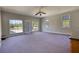Spacious living room with multiple windows offering natural light, carpet flooring, and outside access at 72 Grayson New Hope Rd, Grayson, GA 30017