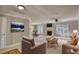 Comfortable living room with fireplace, natural light, and view to dining area at 72 Grayson New Hope Rd, Grayson, GA 30017