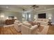 Open living room with sofas, chairs, hardwood floors, and view to the kitchen at 72 Grayson New Hope Rd, Grayson, GA 30017