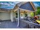 Covered porch with dark wood flooring and ceiling fan with stairs to the backyard at 72 Grayson New Hope Rd, Grayson, GA 30017