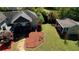 Back of home and yard, featuring a deck, colorful landscaping, and outbuilding at 72 Grayson New Hope Rd, Grayson, GA 30017