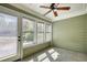 Relaxing sun room with windows and a door leading to the outside at 72 Grayson New Hope Rd, Grayson, GA 30017