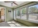 Bright sunroom with large windows, ceiling fan, and neutral carpet creates a versatile living space at 72 Grayson New Hope Rd, Grayson, GA 30017