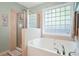Spa-like bathroom features a soaking tub, separate shower, and privacy window at 205 E Skyline Vw, Dallas, GA 30157