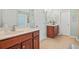 Well-lit bathroom with double sinks, tiled floor, and neutral paint at 205 E Skyline Vw, Dallas, GA 30157