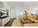 Cozy living room featuring a plush sofa, a white entertainment center, and hardwood flooring throughout at 205 E Skyline Vw, Dallas, GA 30157
