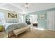 Bright bedroom with tray ceiling, a king bed, and soft blue accents at 205 E Skyline Vw, Dallas, GA 30157