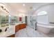 A Luxurious bathroom features a soaking tub, glass-enclosed shower, and dual vanities at 2659 Lakefield Sw Pass, Marietta, GA 30064
