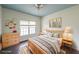 Bedroom with a blue ceiling, light hardwood floors, and a large window for natural light at 2659 Lakefield Sw Pass, Marietta, GA 30064