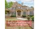 Charming brick two-story home with manicured lawn and mature trees at 2659 Lakefield Sw Pass, Marietta, GA 30064