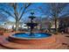 Large tiered water fountain surrounded by a brick patio in a downtown square on a clear day at 2659 Lakefield Sw Pass, Marietta, GA 30064