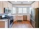 Modern kitchen featuring stainless steel appliances, white cabinets, and tile floors at 2659 Lakefield Sw Pass, Marietta, GA 30064