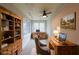 Office featuring a ceiling fan, a large window, and a wooden desk and bookshelf at 2659 Lakefield Sw Pass, Marietta, GA 30064